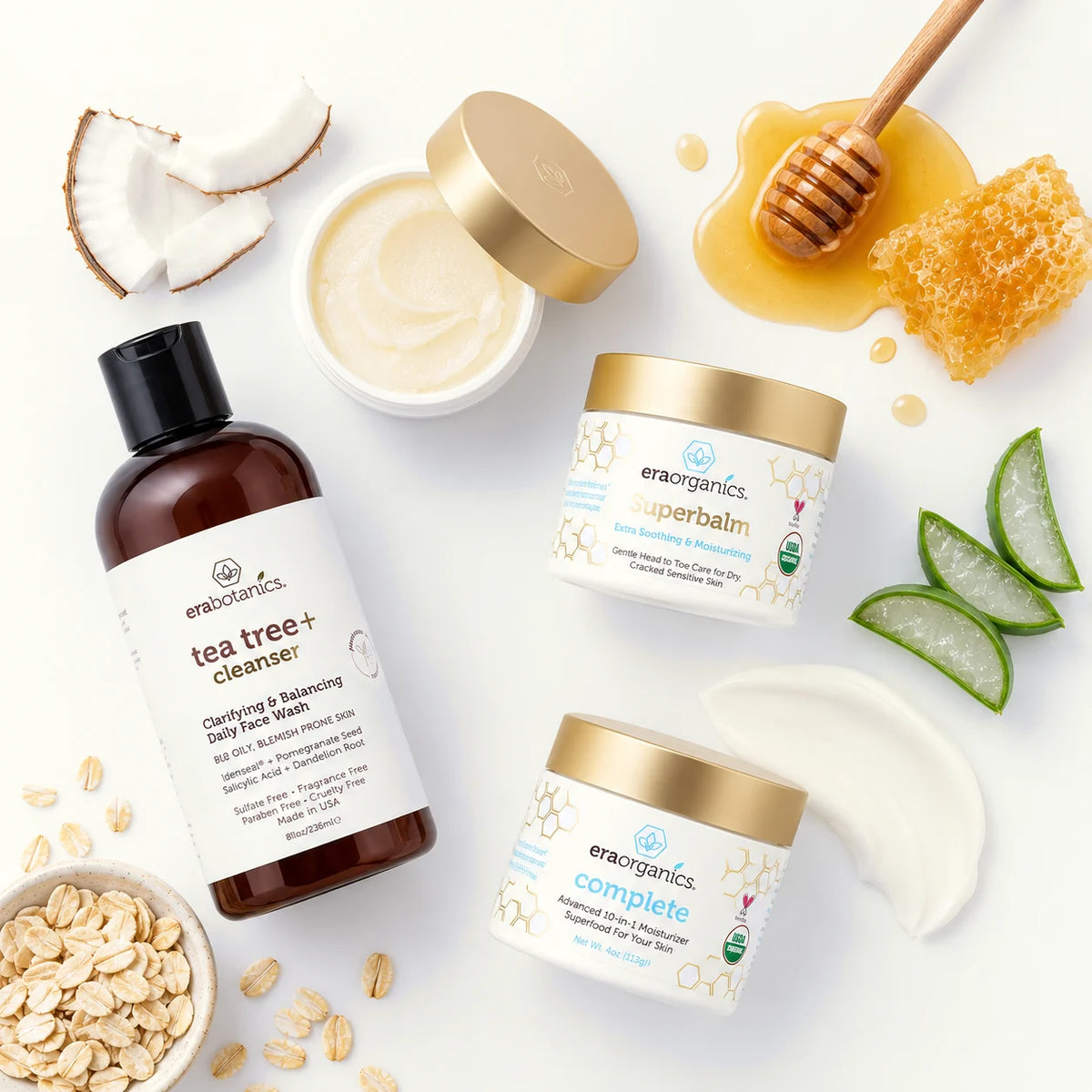 Era Organics Tea Tree+ Cleanser, Superbalm, Complete+ and an open jar among coconut, honeycomb, aloe and oats