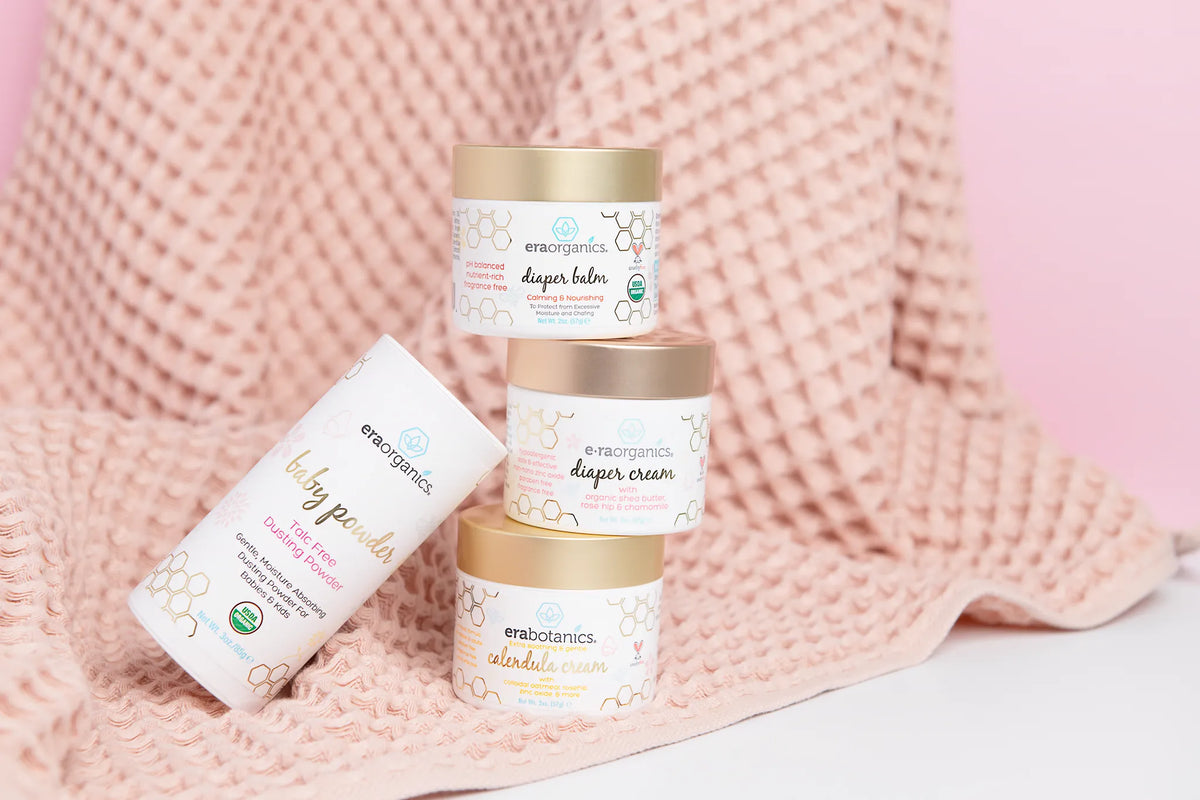 Era Organics baby skin care products on a pink waffle towel