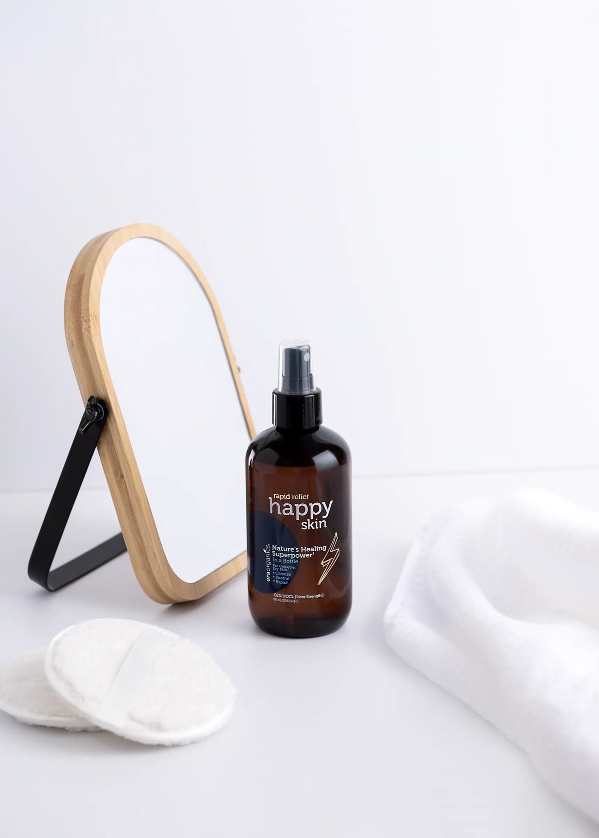 Era Organics Happy Skin hypochlorous acid spray on a bathroom vanity