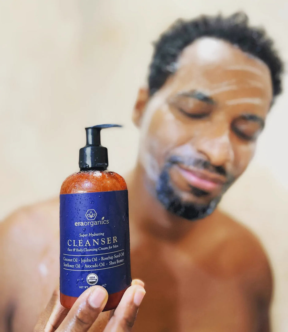Man holding a bottle of Era men's cleanser